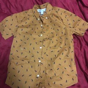 Short sleeve button down shirt with blue dinosaurs